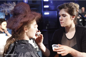On the set of 'Face Off,' contestant Emily Serpico, a Palm Beach State Cosmetology graduate, applies special effects makeup.